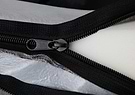 Close-up of zipper on Bolstr bed outer cover, showing memory foam inside
