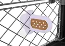 Groov Crate Training Aid in Lilac, attached to the mesh of a dog crate, with peanut butter spread on the grooves