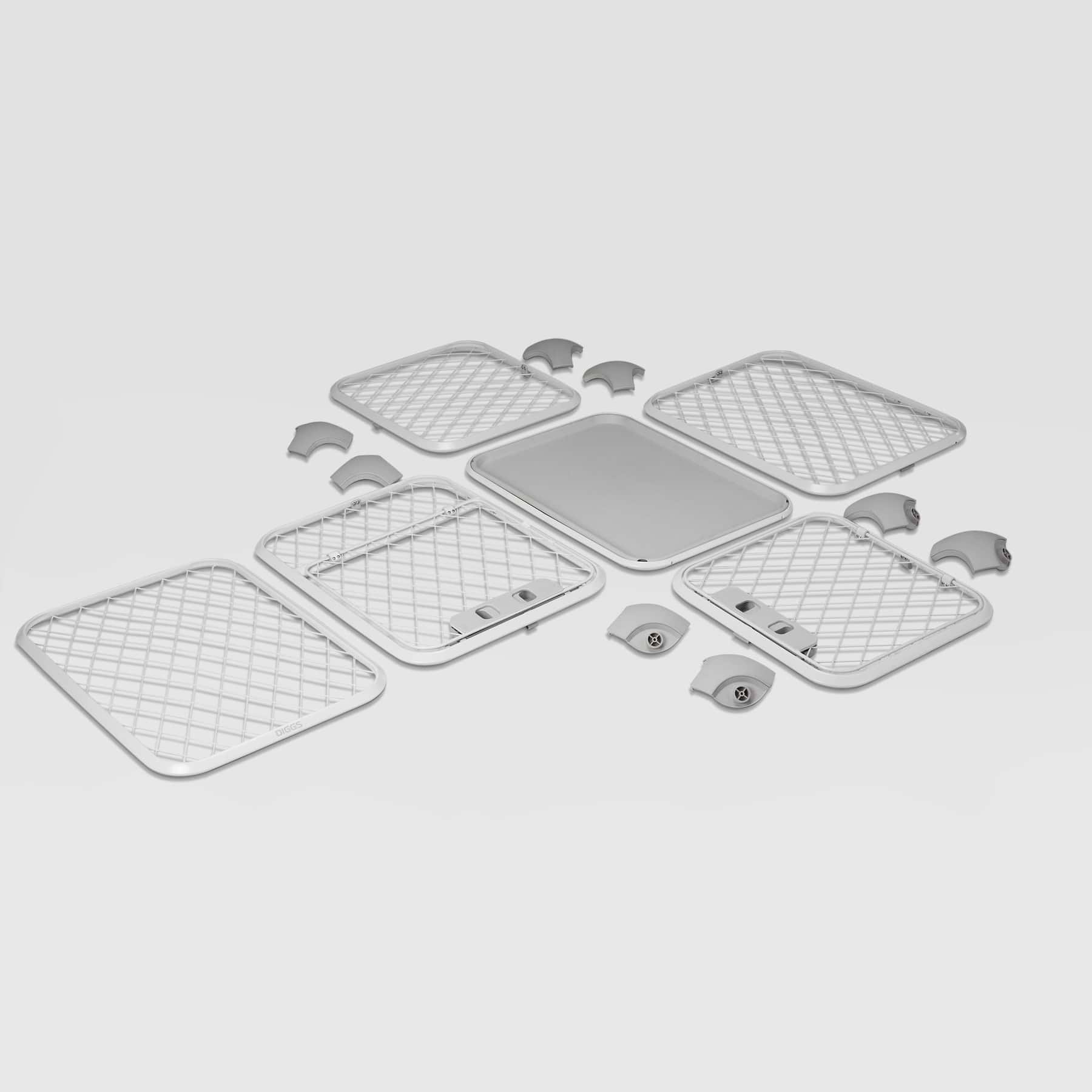  Components of Evolv dog crate disassembled, laid out on a white floor 