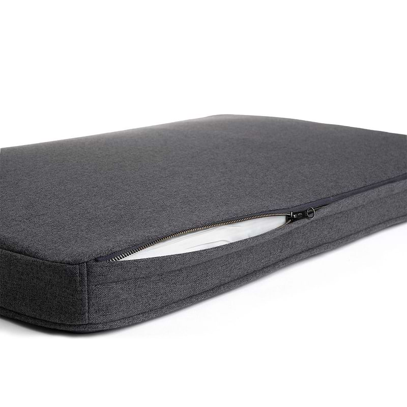 a close up of a dark grey Snooz with the outer cover partially unzipped