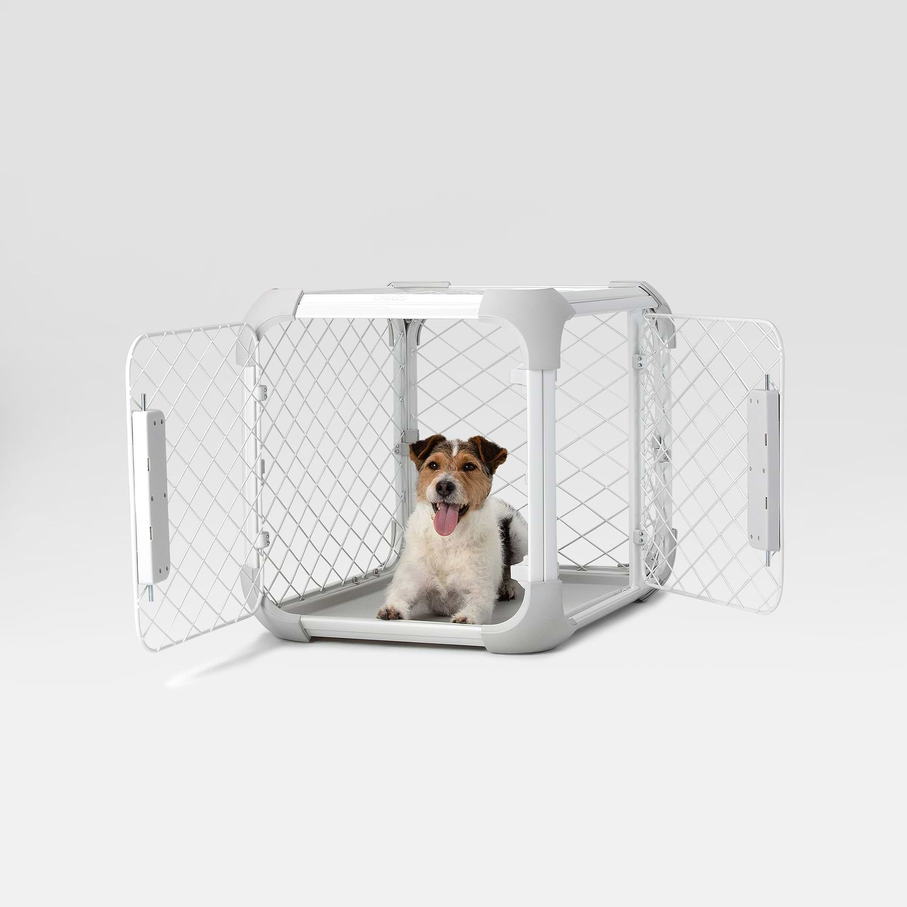  a dog sitting inside of an Evolv crate with the front and side doors open 