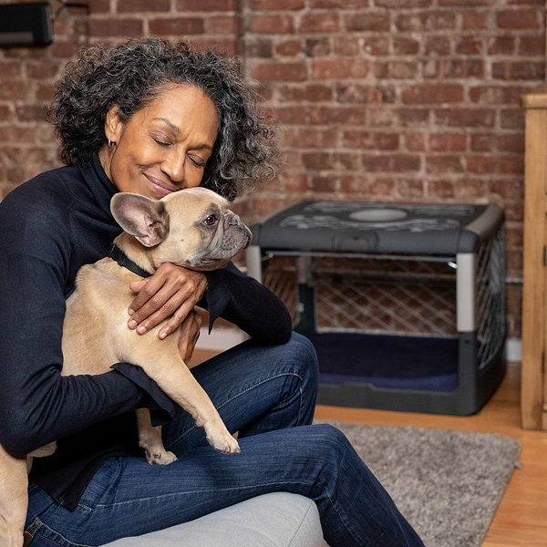  The owner hugging her dog while sitting in a couch next to an open garage door Revol. 