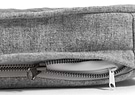  a close up of a grey snooz pad with the outer cover partially unzipped 