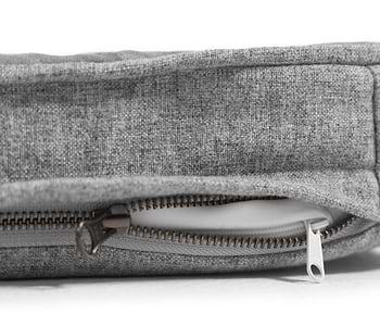 a close up of a grey snooz pad with the outer cover partially unzipped 