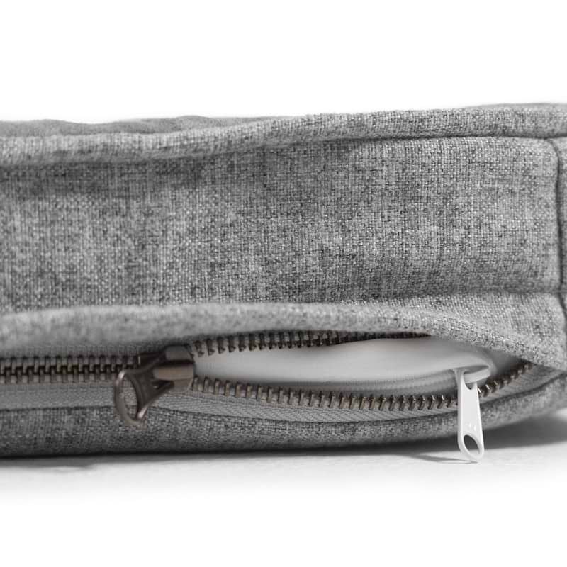  a close up of a grey snooz pad with the outer cover partially unzipped 
