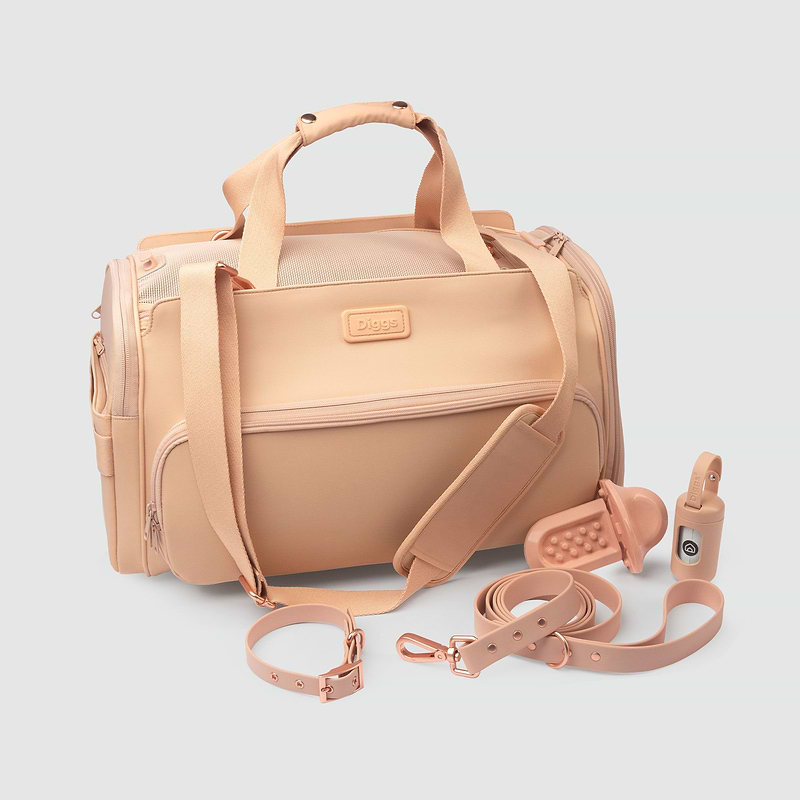 A blush Passenger pet carrier bag with a matching leash and strap