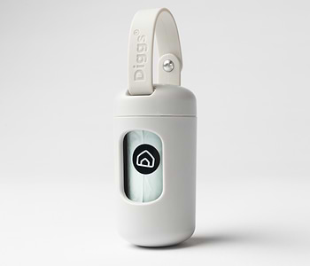  A Diggs Dispenser in Ash(off white) with an extra strap and with a poop bag inside it. 