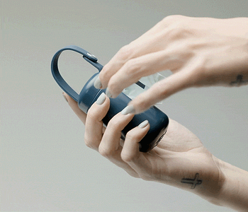  a woman is pulling a poop bag out of a navy dispenser 