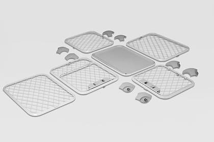 Components of Evolv dog crate disassembled, laid out on a white floor