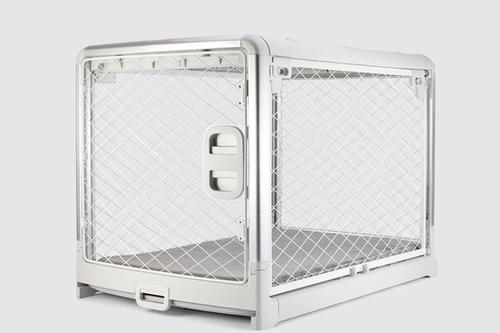 A white metal dog crate with open doors