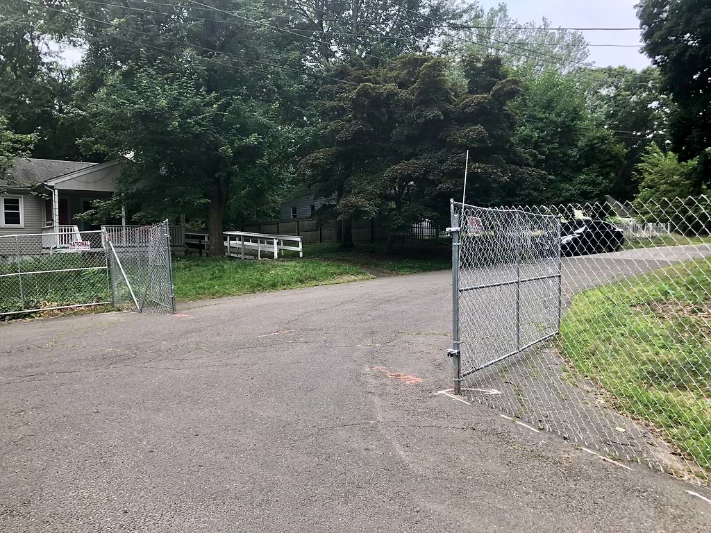 Chain-link fencing has been erected on Hiawatha Lane Extension, walling off the houses that are to be demolished for a 157-unit development. / Photo by Thane Grauel.