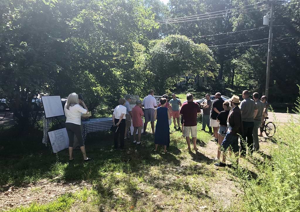 Neighbors listen to a presentation about possible upcoming construction of a 157-unit apartment complex at the end of Hiawatha Lane Extension. / Photo by Thane Grauel.