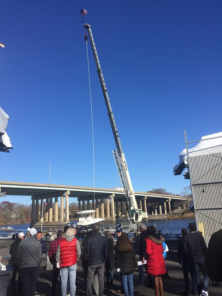 A crane with pennants marking 80 feet, just below the hook, 70 below, and 60 feet after that, to illustrate heights of buildings sought at different distances from the Saugatuck River. / Photo by Thane Grauel
