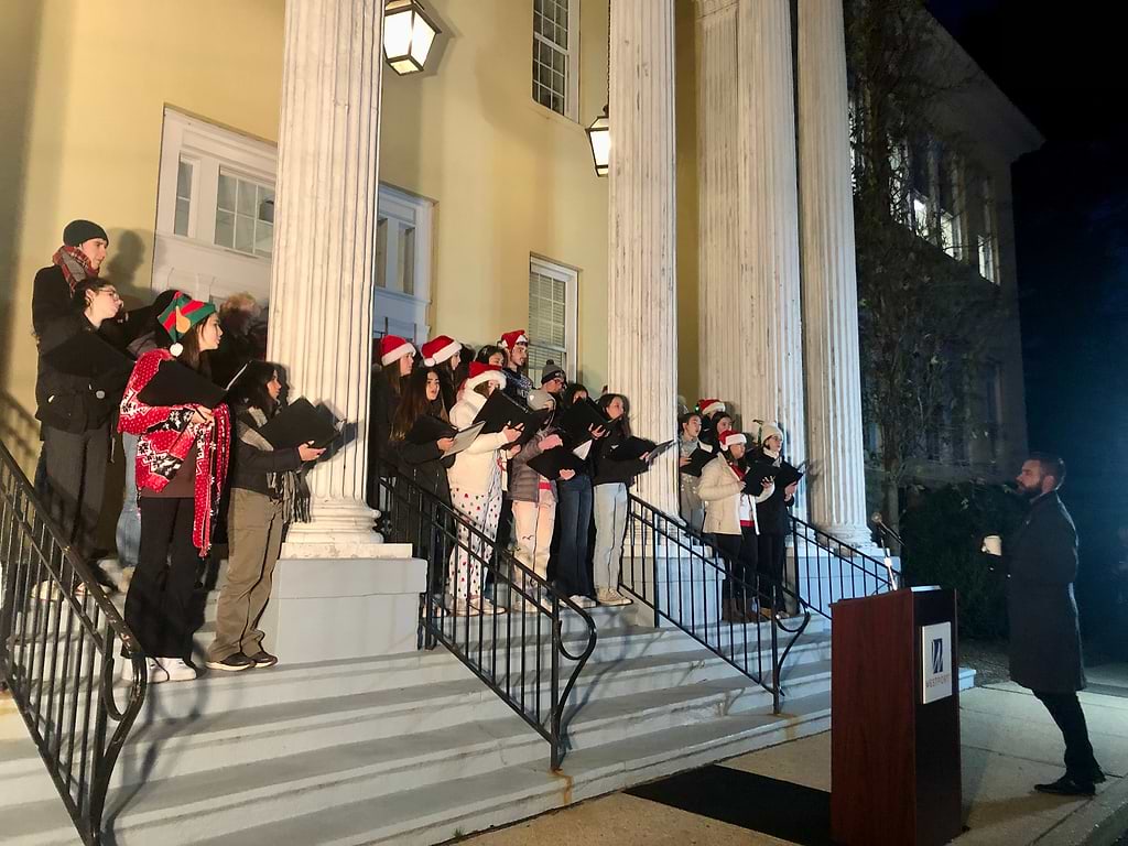The Staples Orphenians sing on the steps of Town Hall before the town's Christmas tree lighting on Thursday. / Photo by Thane Grauel