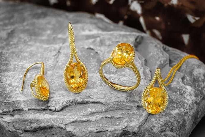 An oval citrine ring, pendant and earrings