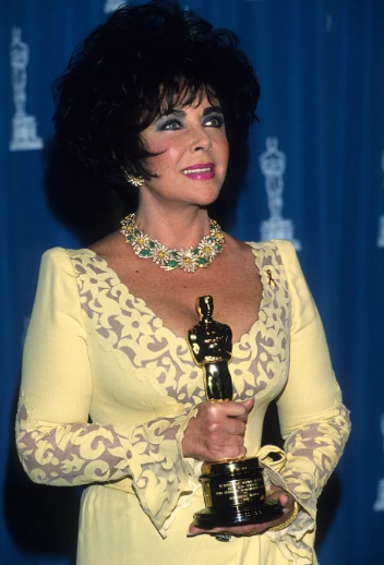 Elizabeth Taylor wearing Van Cleef & Arpels yellow diamond earrings, necklace, and brooch