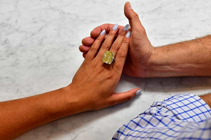 Admiring a yellow diamond ring up close