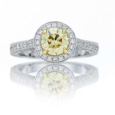 1.01 Carat, Fancy Yellow round mounted in a full pave halo ring with a delicate millgrain edge
