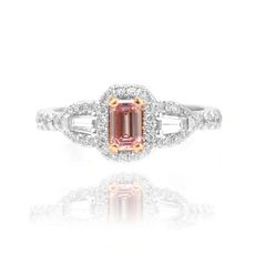 Pink emerald  shape set in a Halo and Taper accent engagement ring
