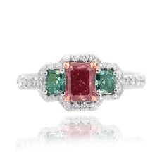 Red_emerald-_shape_set_in_a_Halo_and_radiant_accent_engagement_ring