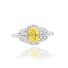 Yellow_oval-_shape_set_in_a_Halo_and_half_moon_accent_engagement_ring