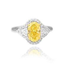 Yellow_oval-_shape_set_in_a_Halo_and_Triangle_accent_engagement_ring