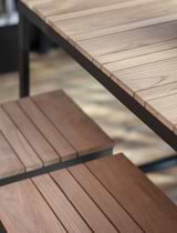 Close up of Camley Teak and Steel Bar Table Set