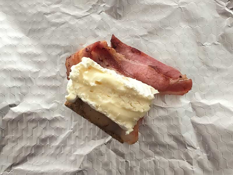 Camembert layered onto bacon and a cracker