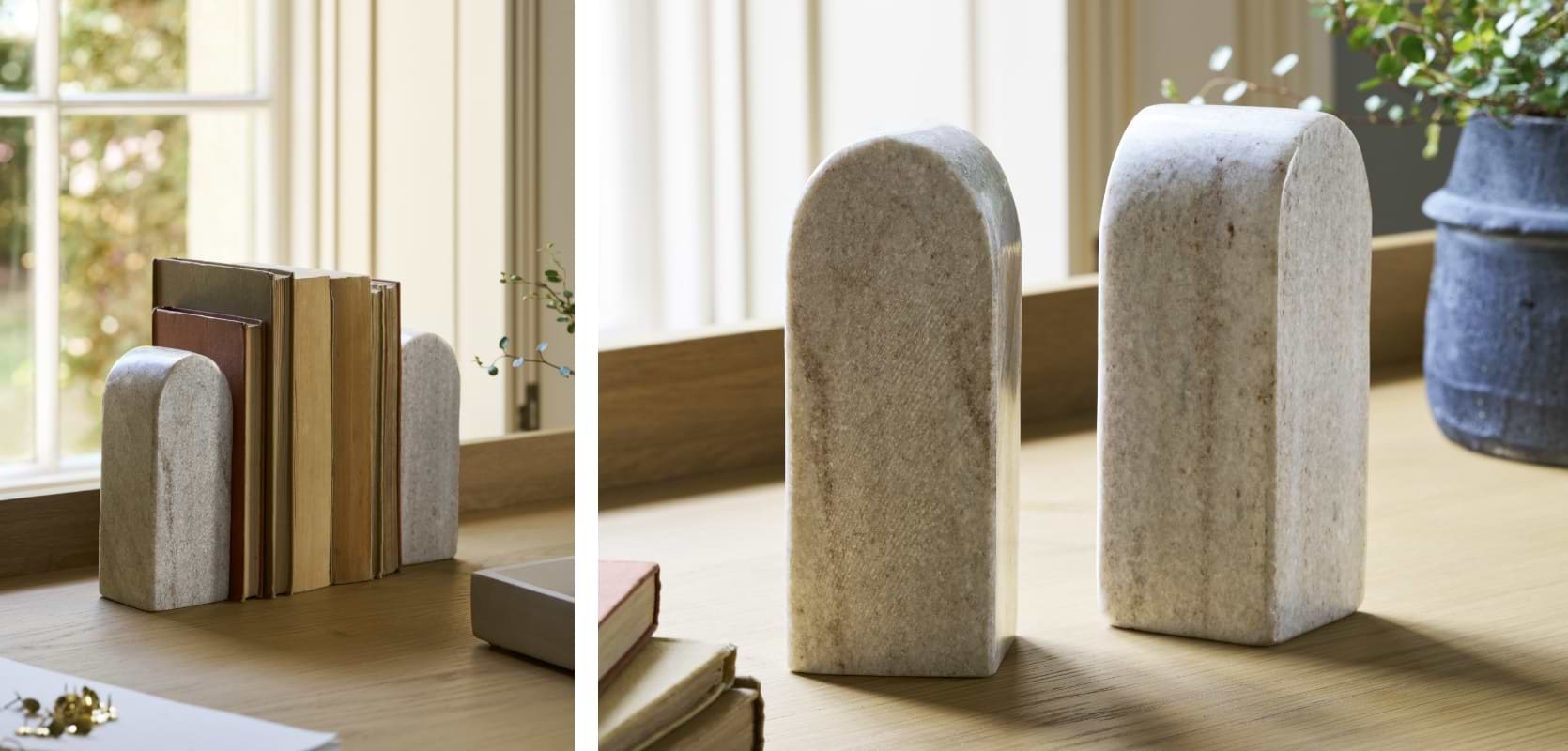 Pair of solid marble Osney Bookends with natural veining, holding books on a wooden shelf in a stylish home office.