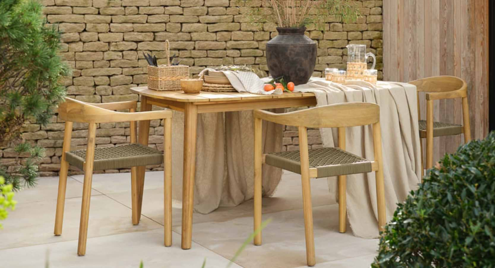 Harford Dining Table in natural finish, designed to fit four chairs, crafted from solid acacia for a robust and weatherproof outdoor dining experience.