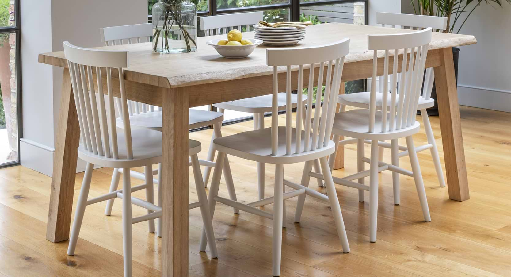 Hambledon Oak Dining Table in natural finish, featuring a distinctive grain and live-edge design, seating 6-8 people.