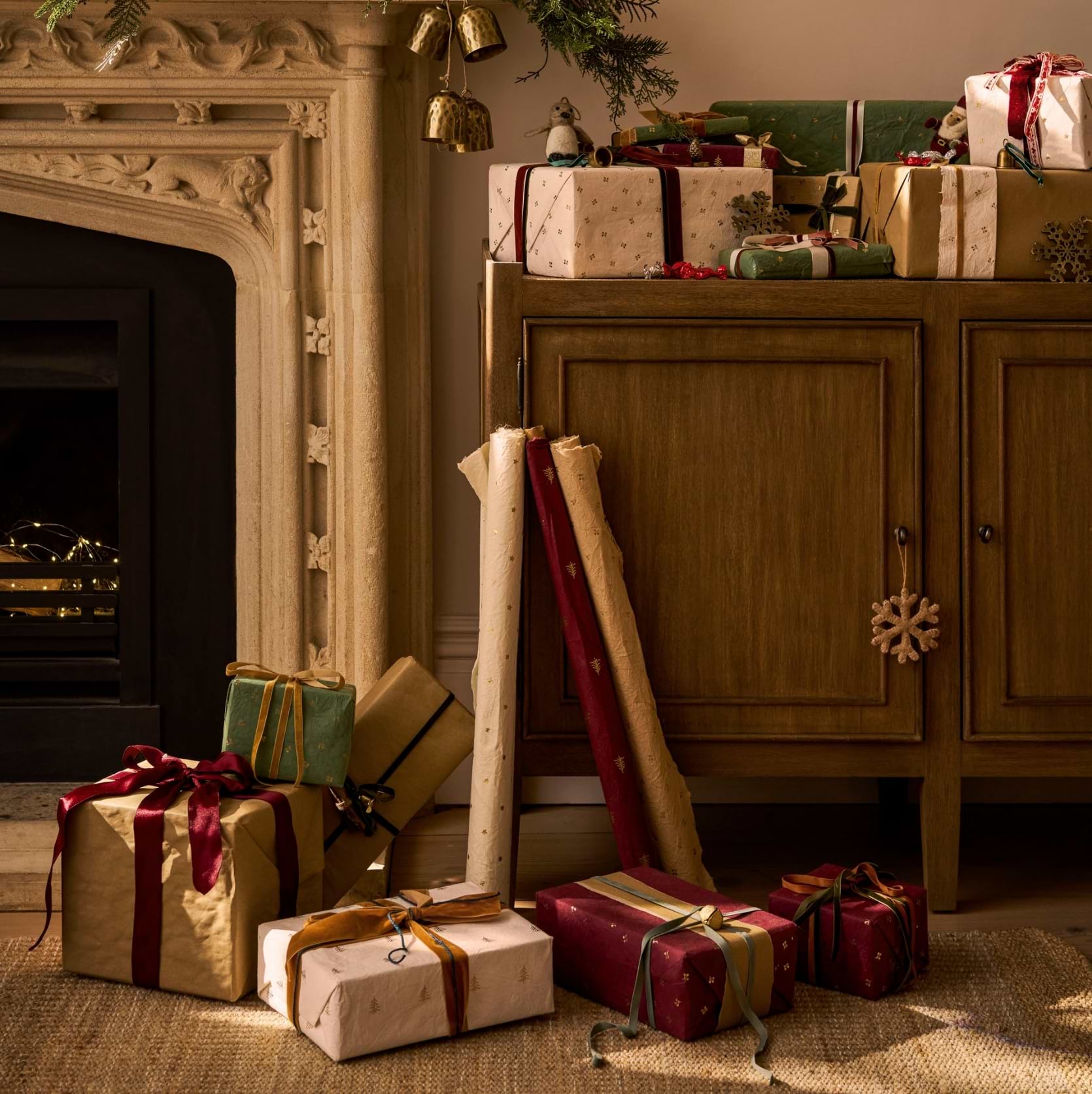 Recycled-cotton warm white and berry wrapping paper featuring three gold foil prints of berries, trees and stars – Maddox by Garden Trading.