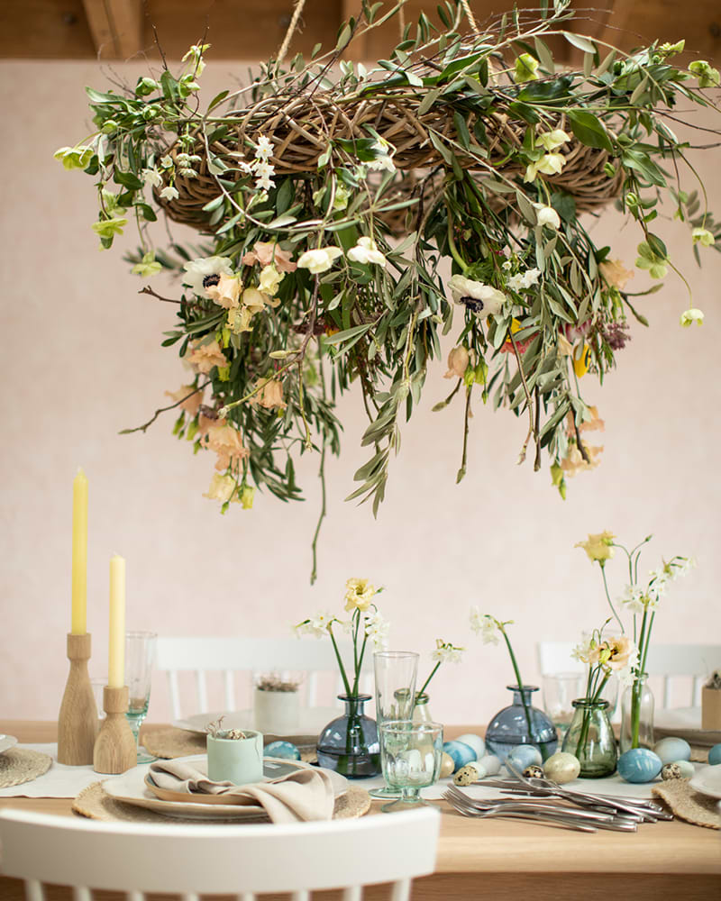 set table with wooden weave basket and flowers above