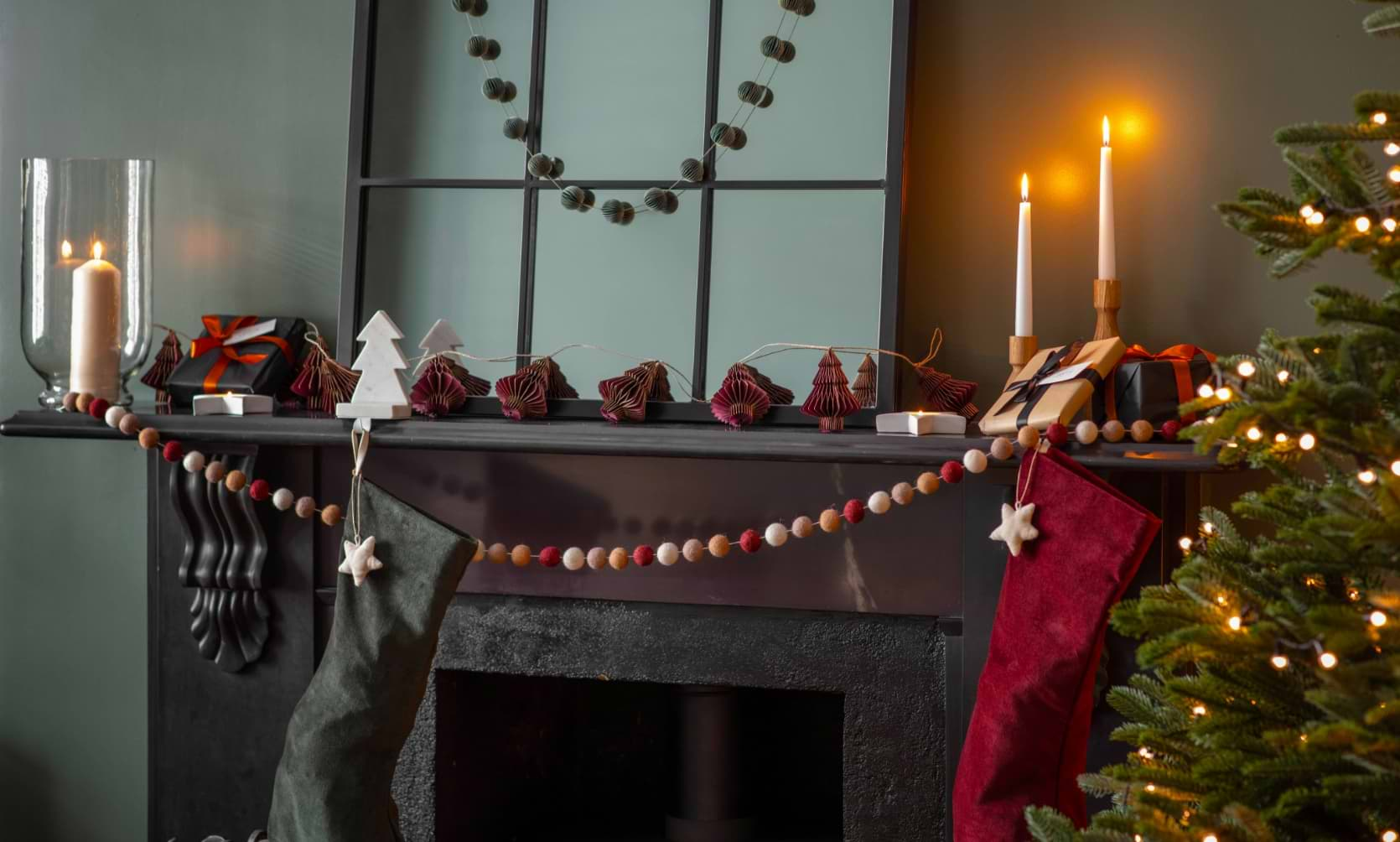 Fireplace adorned with stockings, wrapped presents, candlesticks, and the Fulbrook mirror hanging above.