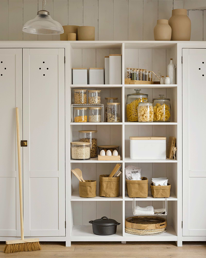 Organised pantry in white with multiple storage jars