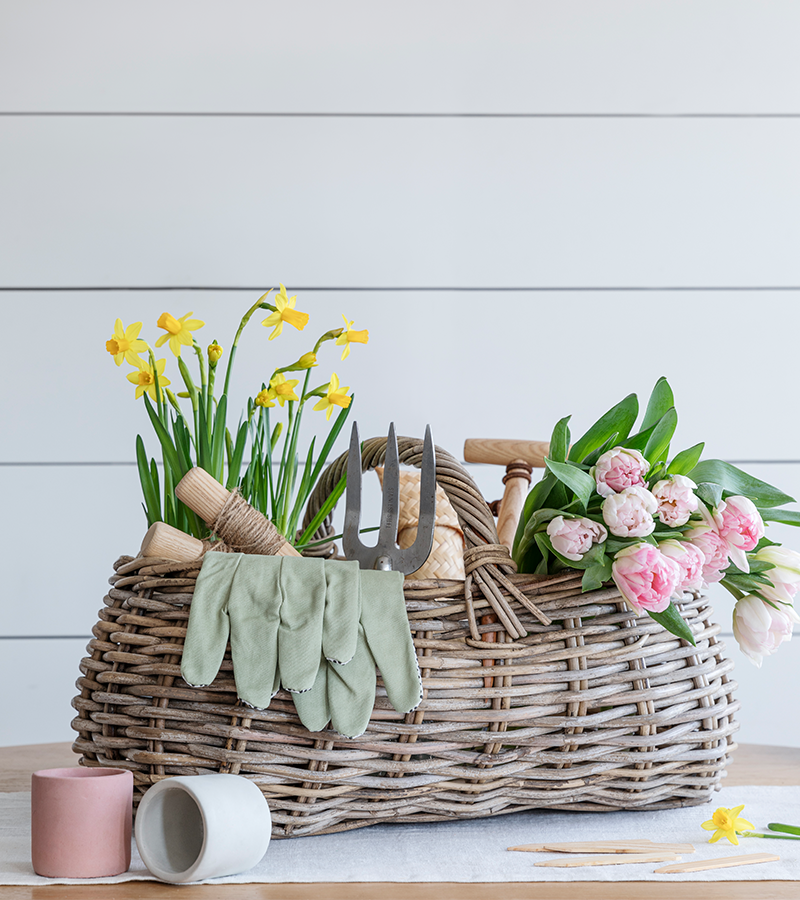 weave basket with gardening tools and flowers
