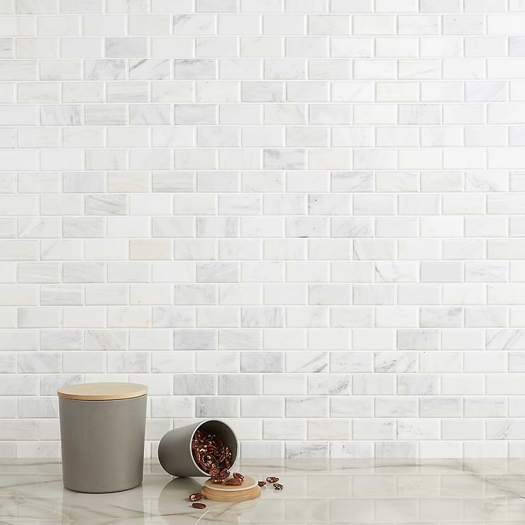 Asian Statuary White 2x4 Beveled Brick Polished Marble Mosaic; in White base with gray and gold veining Asian Statuary; for Backsplash, Kitchen Wall, Wall Tile, Bathroom Wall, Shower Wall, Outdoor Wall; in Style Ideas Classic, Contemporary, Craftsman, Modern, Traditional, Transitional
