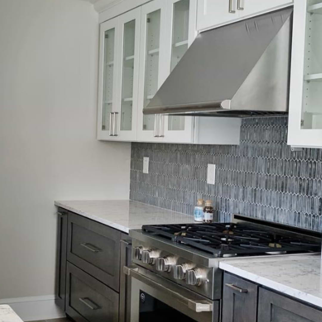 A modern kitchen with blue mosaic glass backsplash.