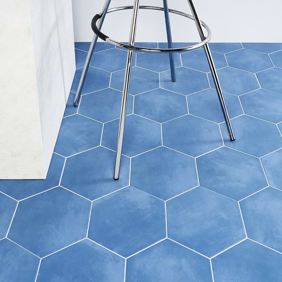 blue hexagonal tiles with white grout shown on a kitchen floor 