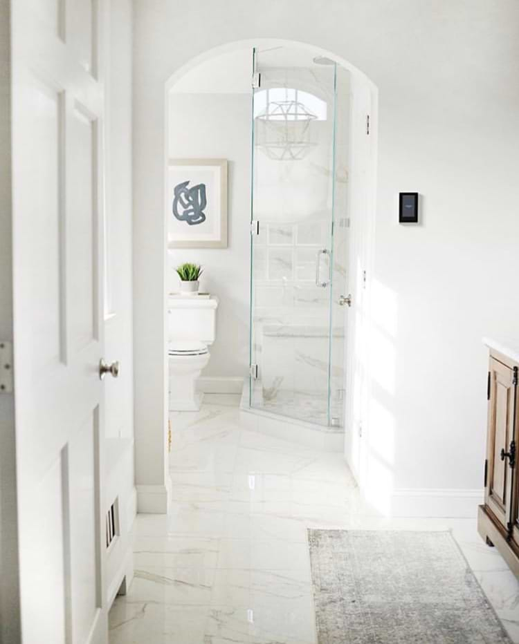 Belvedere Bianco 30x30 Marble Look Porcelain Tile shown n the floor and walls of a modern bathrooom