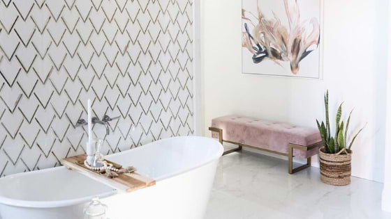 luxurious geometric tiles feature wall in a bathroom with marble look tiles on the floor of bathroom
