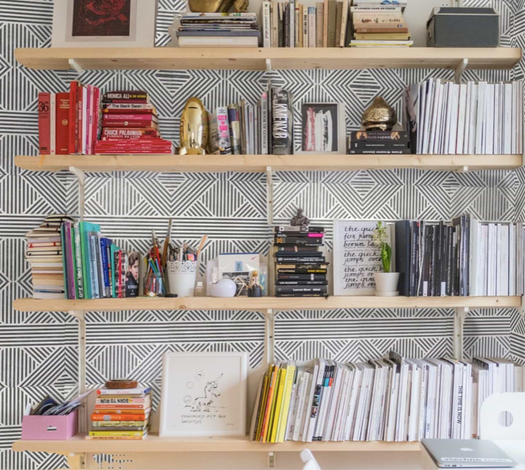 Nolita 24x24 Matte Porcelain Tile shown on the wall behind wooden book shelf