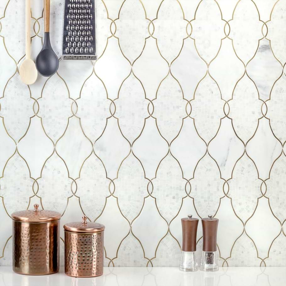 Example of Luxury Waterjet Mosaics with a brass inlay to create geometric patterns used in kitchen as a wall tile