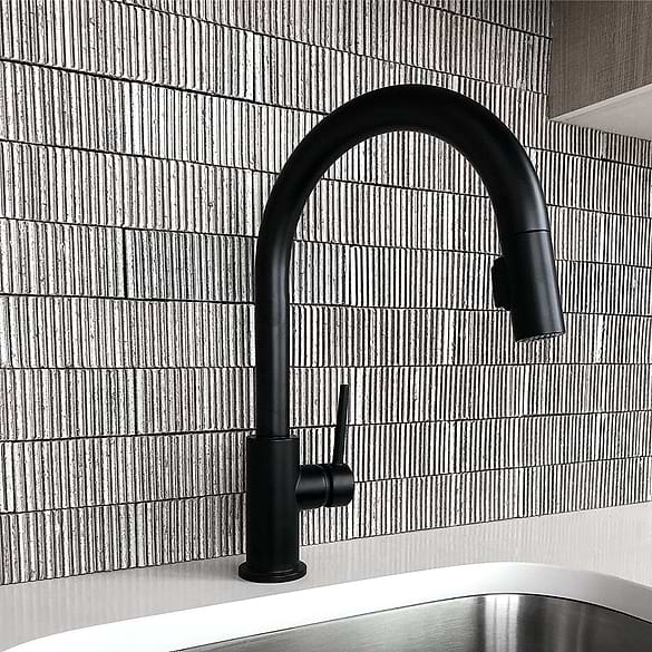 metallic ceramic backsplash with matte black sink faucet