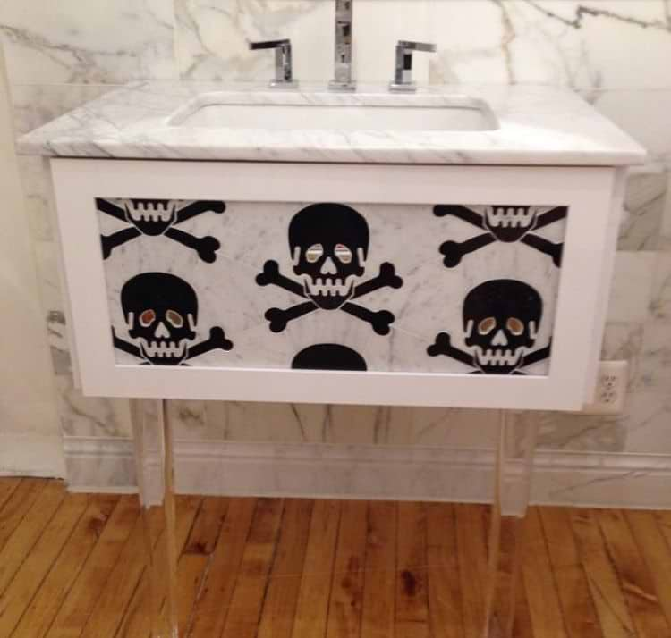 Live Free Marble & Mirror Tile shown on a sink unit. The live free design is a large black skull and crossbones with mirrored eyes. 