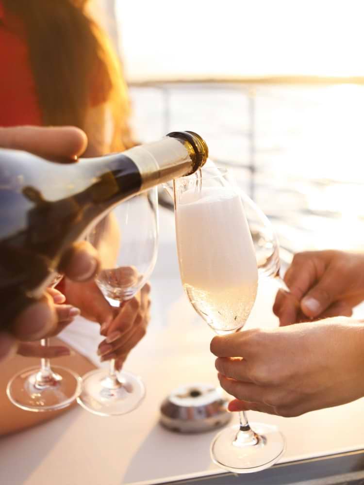 pouring champagne on a boat