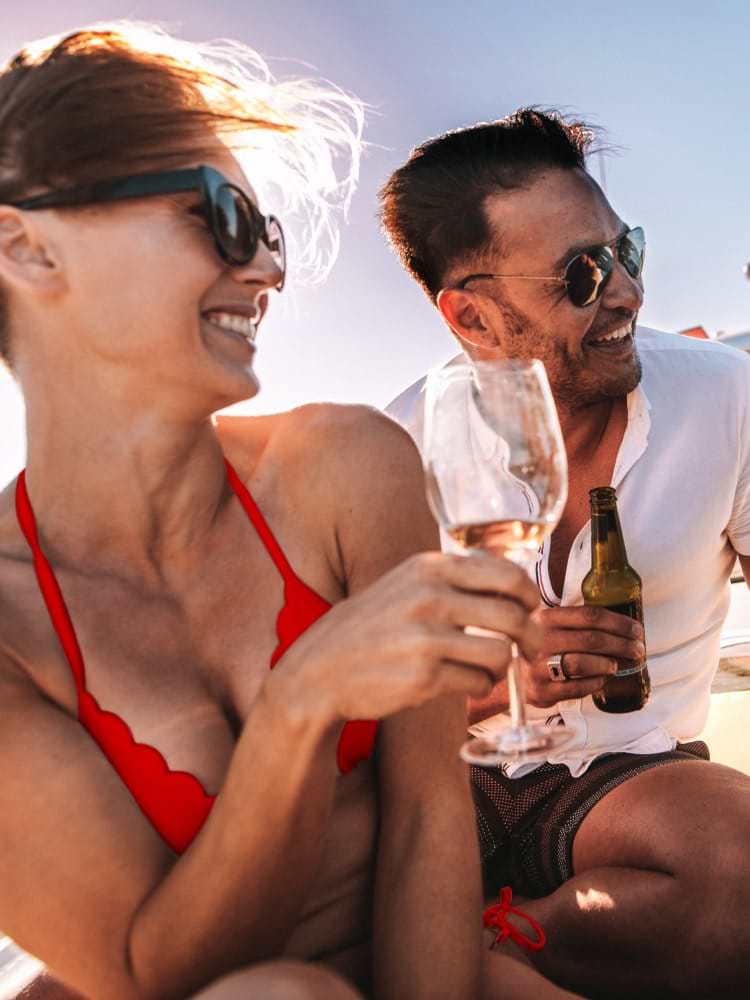 Man and woman smiling with drinks