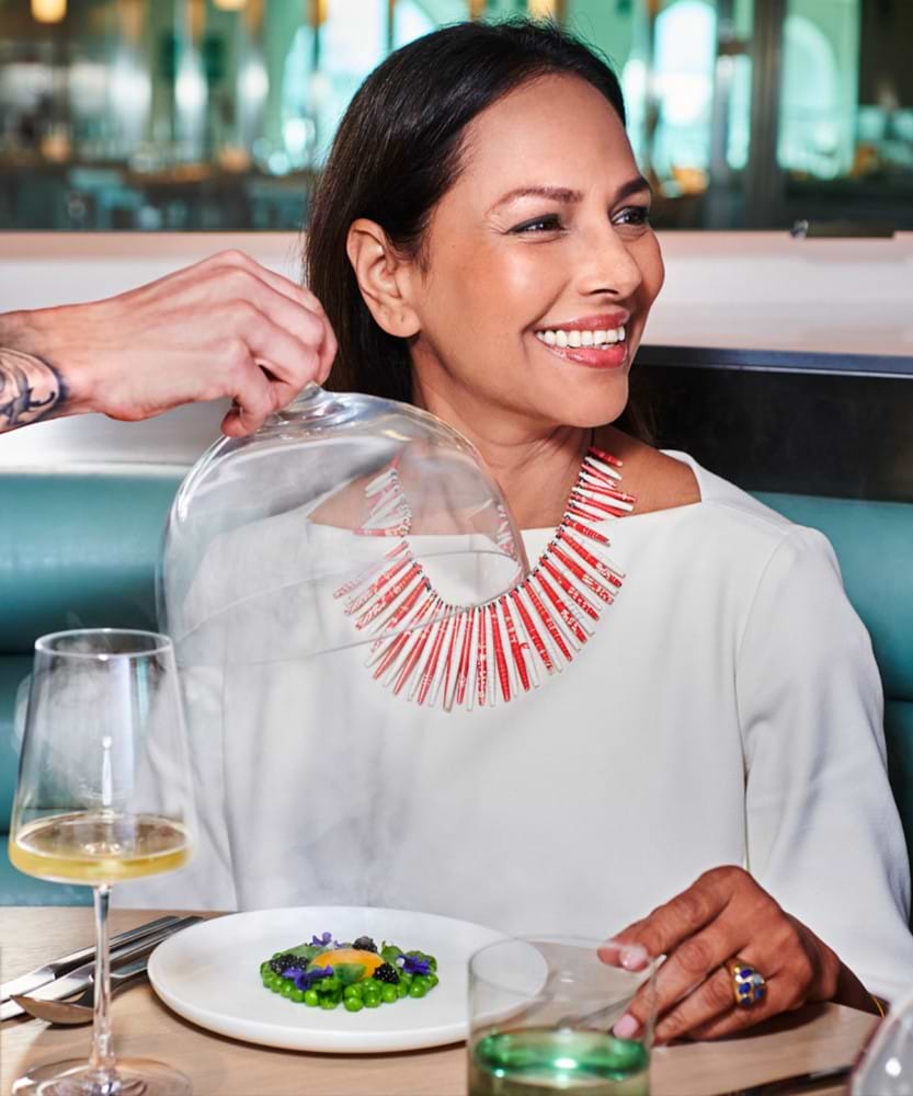 close shot of woman smiling at dinner