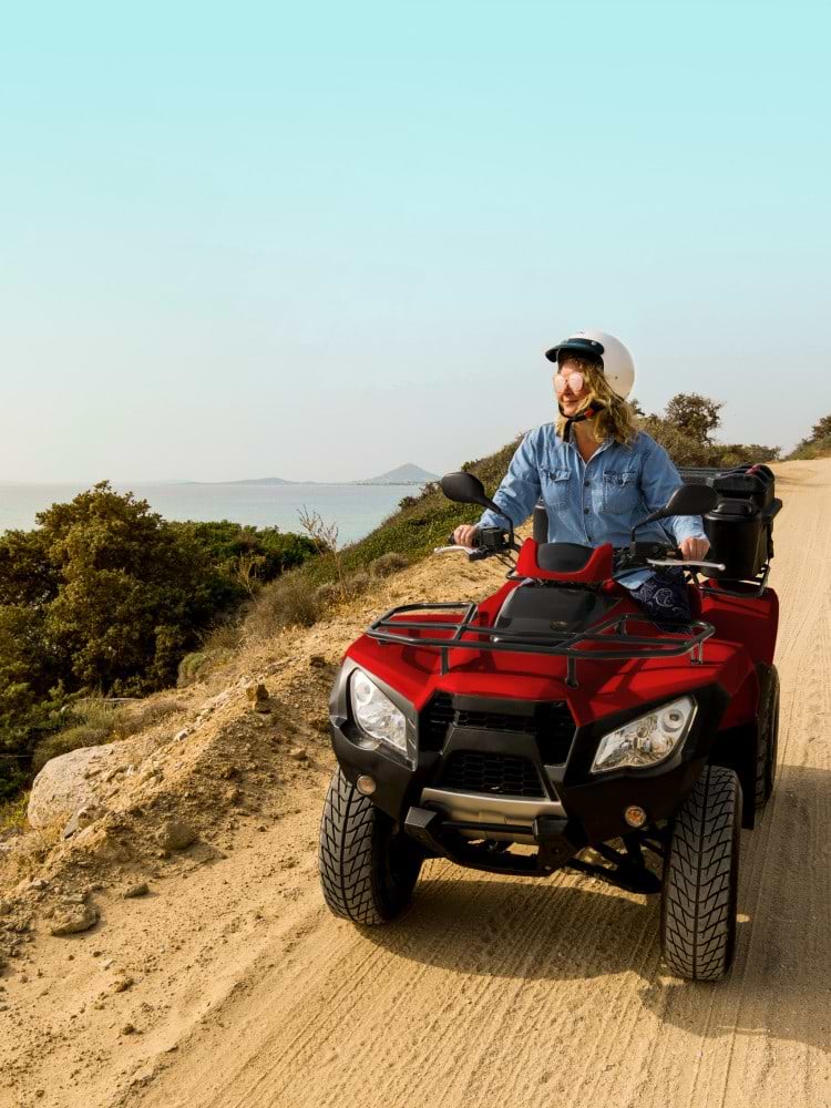 Woman Riding on Four Wheeler Bike on back road