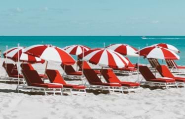 Red beach cars and red and white umbrellas